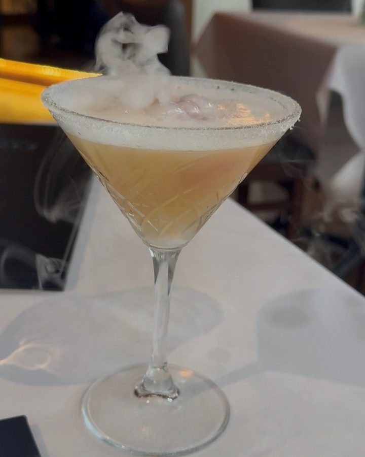 The Voila cocktail at Truluck's in downtown Naples, smoking in a sugar-rimmed martini glass